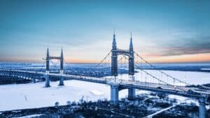 Aerial view of Yangmingtan Bridge over the frozen Songhua River at sunset in Harbin, China.