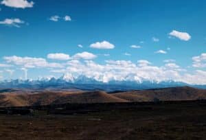 - Wide shot of the snow-capped Gongga Mountain range viewed from Yuzixi plateau in Kangding, Sichuan, China.