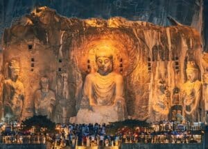 Illuminated giant Buddha statues at the Longmen Grottoes, a UNESCO World Heritage Site in Luoyang, Henan, China.
