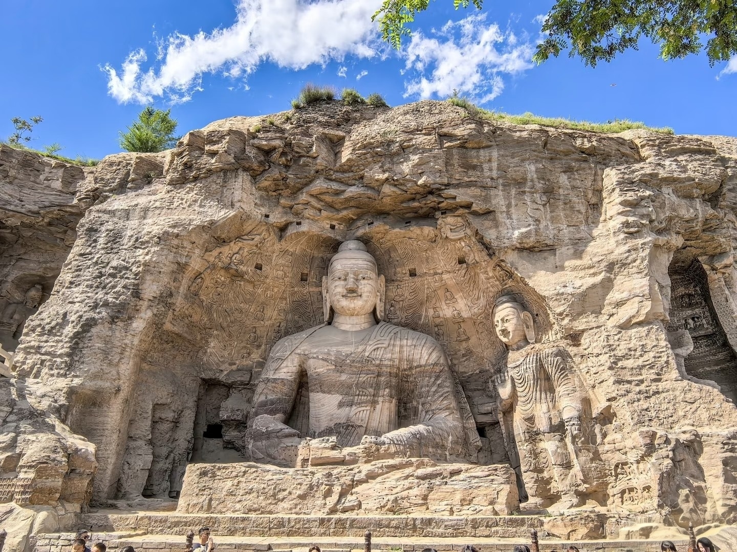 - Giant Buddha statue carved into the rock face at Yungang Grottoes, a UNESCO World Heritage Site in Datong, Shanxi, China.