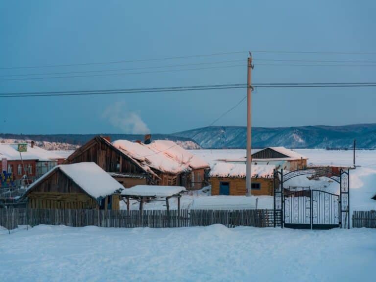 Traditional wooden houses covered in thick snow in Arctic Village, the northernmost point of China in Mohe.